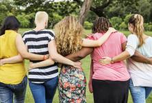 photo of women linking arms